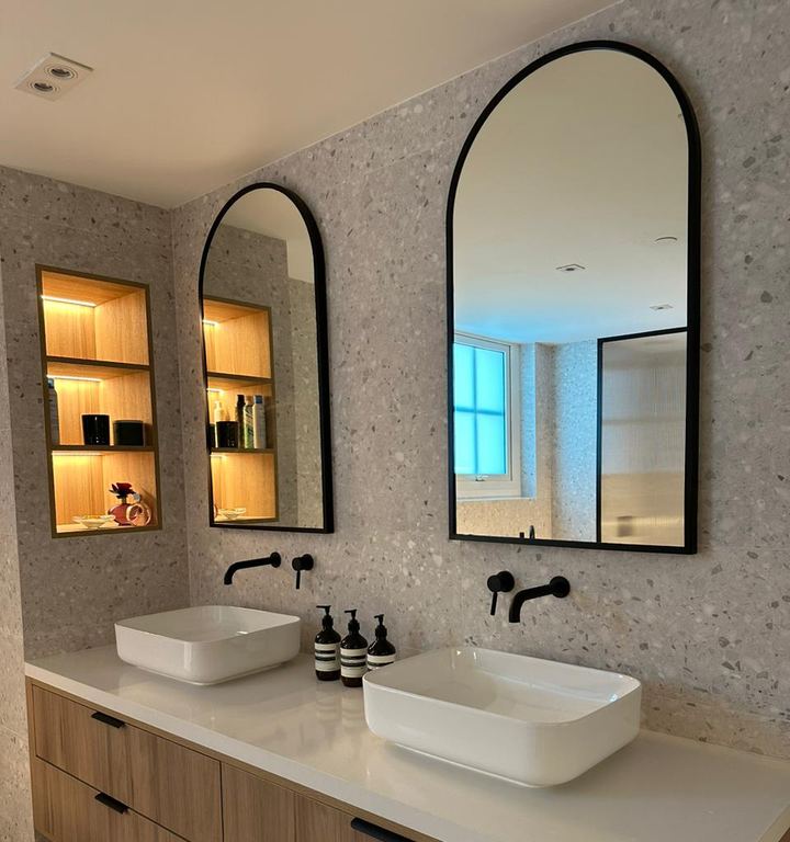 Completed bathroom with arched mirrors