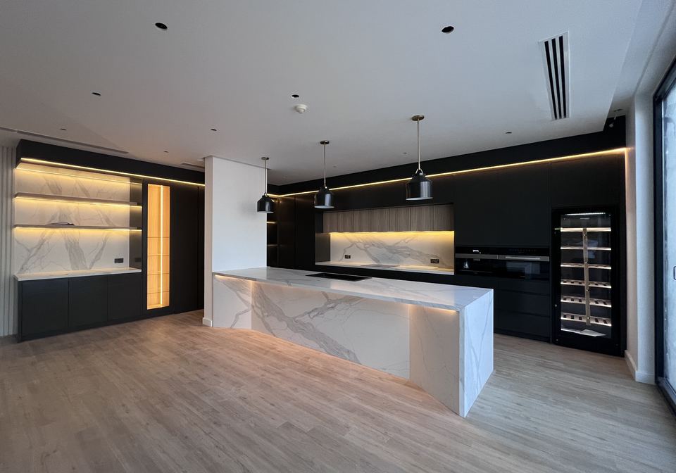 Completed kitchen with a marble island